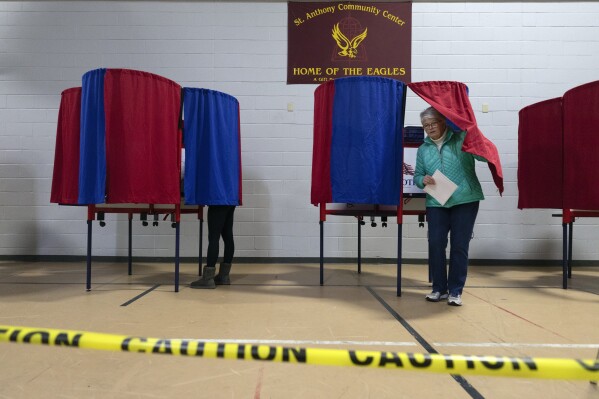 A voter leaves a polling booth at St. Anthony Community Center during the presidential primary election, Tuesday, Jan. 23, 2024, in Manchester, N.H. (AP Photo/Michael Dwyer)